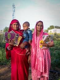 Women of the community holding books